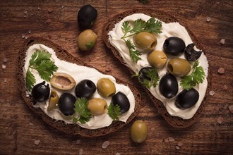 Breakfast, sandwiches, with cream cheese, olives, top view