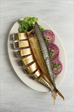 Smoked mackerel, top view, with spices, on a wooden table, no people, selective focus