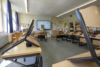 Classroom of a fourth grade, after school, the building is older but in good condition, modern