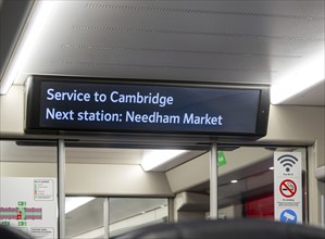 Electronic passenger information sign onboard train service Ipswich to Cambridge, England, UK, next