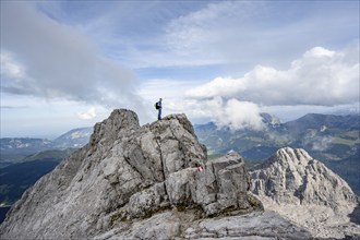 Mountaineer on a narrow rocky ridge, Watzmann crossing to Watzmann Mittelspitze, view of mountain