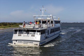 Island ship with passengers on the upper deck sailing across the sea on a sunny day, Rügen