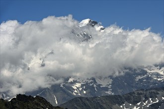 Combin du Valsorey in the Grand Combin massif looks out of the clouds, Valais, Switzerland, Europe