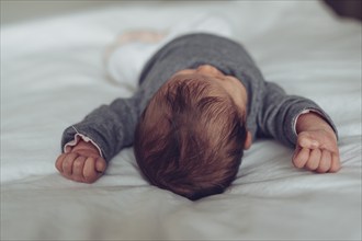 Sleeping baby lies peacefully on the bed