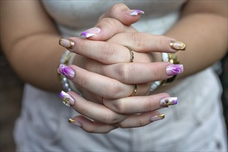 Colourful fingernails of a young woman, Baden-Württemberg, Germany, Europe