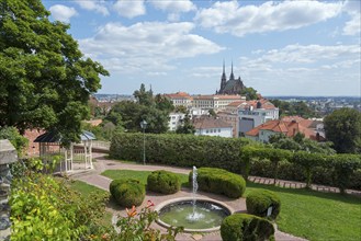 View of a cathedral surrounded by residential buildings and green areas on a sunny day, view from