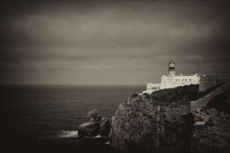 Lighthouse Farol do Cabo de São Vicente, Cape St. Vincent, Sagres, cliffs, Atlantic Ocean, black