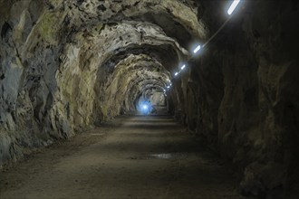 Dark tunnel with illuminated stone walls and a mysterious atmosphere, Klein Tibet, Zillertal,