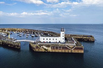 Scarborough Lighthouse and Harbour from a drone, Vincent Pier, Scarborough, North Yorkshire,