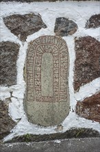 Rune stone embedded in a wall in Glemmingebro, Ystad Municipality, Skåne County, Sweden,