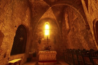 Chancel of the monastery church, church interior with warm evening light, altar and cross, Gothic