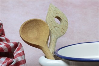 Cooking spoon on saucepan handle