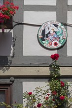 Schützenfest plaque on house wall, flowers, half-timbered house, Hildesheim, Lower Saxony, Germany,