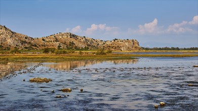 Wetland with a view of mountains and a white cloudy sky, Strofilia biotope, wetlands, Kalogria,