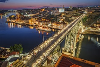 View of illuminated Porto city and Douro river and Dom Luis bridge I from famous tourist viewpoint