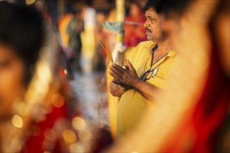 Hindu devotees perform rituals as they offer prayers to the Sun god in the bank of Brahmaputra