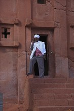 Lalibela, eastern group of rock-hewn churches, pilgrims at the entrance to the Bete Abba Lebanon,