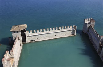 Harbour basin of the castle with flat Guelph battlements, Scaliger Castle, Castello Scaligero, in