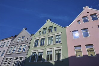 Multicoloured facades of traditional buildings under a clear, sunny sky, Bergen, Vestland, Norway,