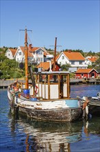 Old fishing boat at the jetty in an old fishing village on the Swedish west coast, Hamburgsund,