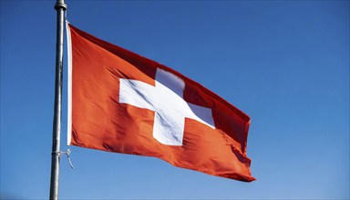 Flag, the national flag of Switzerland flutters in the wind