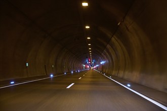 Motorway tunnel A71 with illuminated road and modern light installations offering a perspective