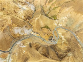 Steaming hot springs and colourful rhyolite mountains, aerial view, Hveradalir geothermal area,