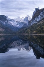 The Vordere Gosausee lake in autumn with a view of the Dachstein mountain range. The Gosaukamm on