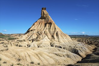 A stony natural monument in an arid desert environment under a blue sky, Castildetierra, Bardenas