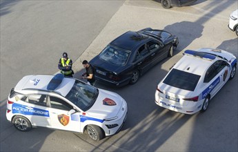 Looking down of Traffic police checking a vehicle, Mother Theresa Rinas Airport, Tirana, Albania,