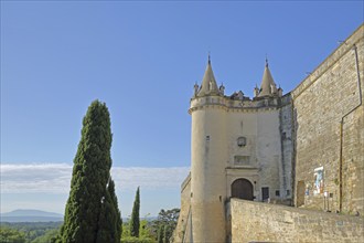 Historic twin towers with ramparts at the entrance to the castle, town fortifications, cypress,