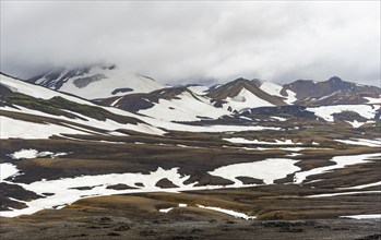 Dramatic volcanic landscape with mountains and snow, at Höskuldsskáli hut in Hrafntinnusker,