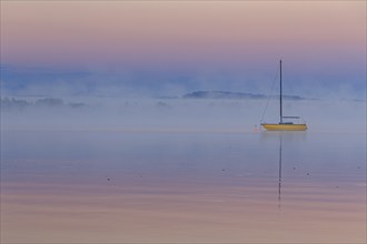 Sailboat reflected in lake, morning mood, peace, silence, fog, Lake Starnberg, Bavaria, Germany,