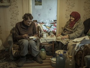 Varvara, 85, and her son Leonid, 56. Leonid looks after his mother, who is in need of care. She