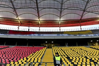 Preparation of a choreography with flags in different colours, stewards, international match