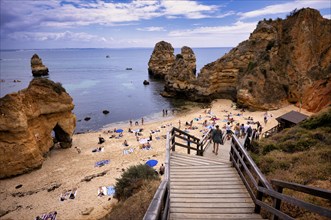 Access via wooden boardwalk, wooden walkway, boardwalk, to the beach, Praia do Camilo, bathers,