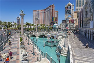 Treasure Island hotel and casino rises up beyond the pools of the Venetian resort on the Las Vegas