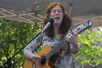 Southfield, Michigan, Claudia Schmidt sings at a backyard concert