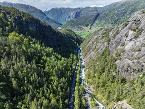 River Oeynaelva and road Rullestadvegen, view down valley to mountains at fjord Akrafjorden,