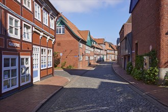 Old half-timbered houses and brick buildings along a street in the historic centre of Stade,