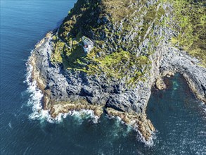 Aerial view of Hendanes Fyr lighthouse, lighthouse located on steep cliff, norwegian coast west of