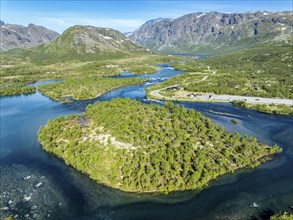 Islands in river Sjoa, famous Besseggen ridge in the back, road to Gjendesheim tourist hut, aerial