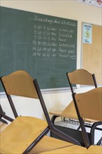 Classroom of a fourth grade, after school, the building is older but in good condition, timetable