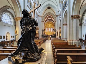 Interior view of Bonn Minster, bronze statue of St Helena with nave and view to the east apse,