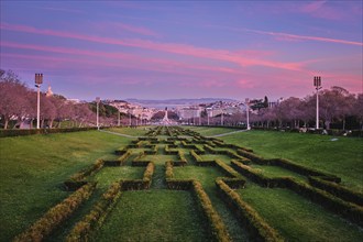 View of Lisbon Marquis of Pombal Square seen from the Eduardo VII Park in the evening twilight.