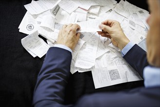 The subject of taxes. A man holds receipts in his hand in Berlin, 09/08/2024