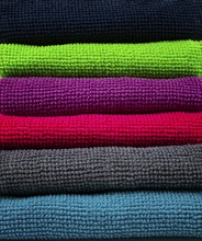 A stack of multicolored, microfiber cloths, for cleaning