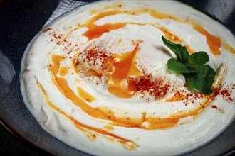 Cilbir, traditional Turkish breakfast, Turkish eggs with yogurt and butter, homemade, no people