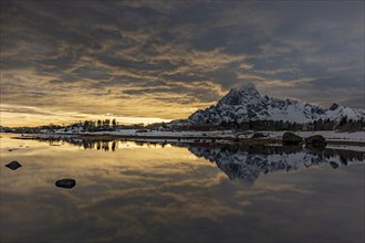 Dramatic evening mood over steep mountains, coast, reflection, Vagakallen, Austvagoya, Lofoten,