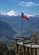 Viewpoint at trail to heart-shaped lake Laguna Corazon, chilenean flag, near Liquine, Chile, South